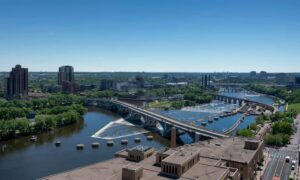 Aerial view of the Mississippi River and downtown Minneapolis showing bridges and flood risk areas connected to FEMA Elevation Certificate requirements