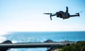 Drone surveying over riverfront land, capturing aerial data for land assessment and redevelopment projects.