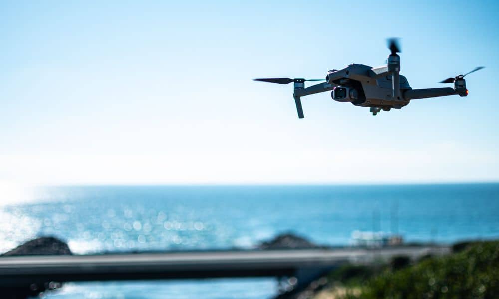 Drone surveying over riverfront land, capturing aerial data for land assessment and redevelopment projects.
