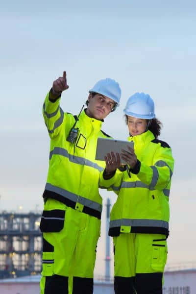 Licensed land surveyor digital data tablet collaboration - ALTA SURVEY Minnesota Licensed land surveyor analyzing digital survey data on a tablet with a colleague, representing technology and collaboration in modern surveying
