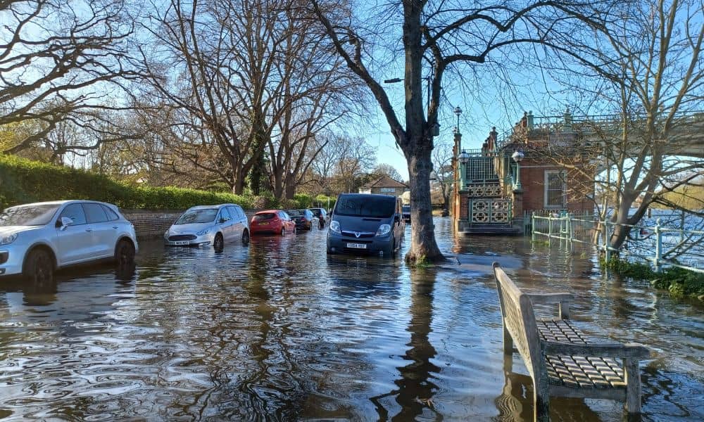Residential street flooding after heavy rain, showing why topographic surveys are important for understanding drainage and elevation changes