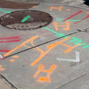 Commercial property surveyor documenting underground utility markings during an urban site survey