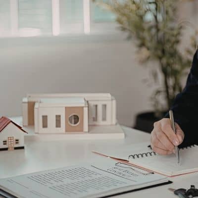 Licensed surveyor reviewing and signing property documents during a professional consultation