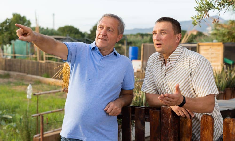 Neighbor property boundary discussion - ALTA SURVEY Minnesota Neighbors discussing a property line issue near a fence before getting a house survey